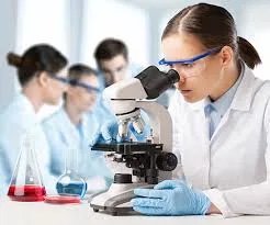 Scientist using microscope in SARMs laboratory testing.