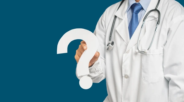 Doctor holding question mark, symbolizing Q&A with a doctor about SARMs trials.